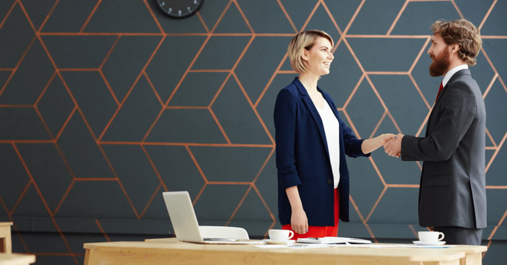 woman shaking man's hand